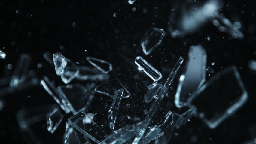 Super Slow Motion Shot of Shattering Glass Shards Flying Towards Camera on Black at 1000fps. Royalty-Free Stock Footage #1096974523