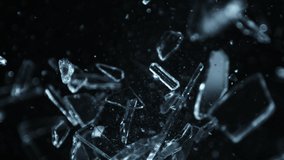 Super Slow Motion Shot of Shattering Glass Shards Flying Towards Camera on Black at 1000fps. - Powered by Shutterstock - Get 15% off with code: PIKWIZARD15
