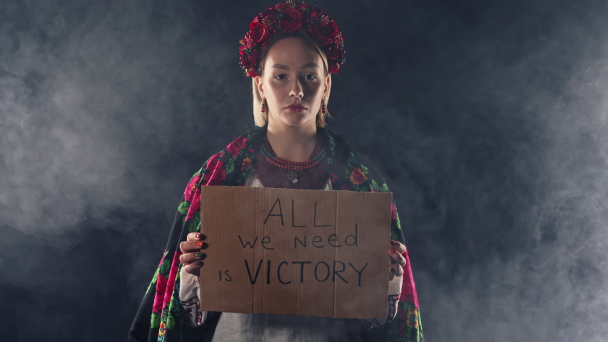 Ukrainian woman with cardboard All we need is victory. Ukraine will win war. Protest, democracy, liberty, demonstration, russian aggresion concept Royalty-Free Stock Footage #1096977879