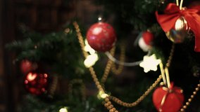 Closeup of christmas ornament decorations, balls and garland hang on Christmas tree. Wrapped red gift boxes and bright lights in living room, copy space. Winter holidays concept. Texture - Powered by Shutterstock - Get 15% off with code: PIKWIZARD15