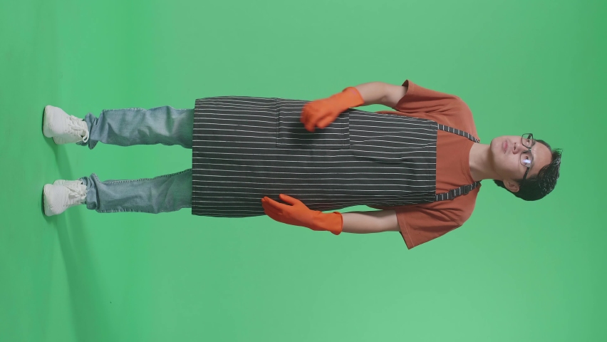 Full Body Of Asian Male Housekeeper With An Apron Thinking About Something And Looking Around While Standing In The Green Screen Studio
 | Shutterstock HD Video #1096979155