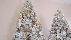 Two Christmas trees beautiful stylish luxury designer christmas tree with gold and silver flowers gifts. Gifts under designer snow tree with lights and balls in beige, gold and silver colors - Powered by Shutterstock - Get 15% off with code: PIKWIZARD15