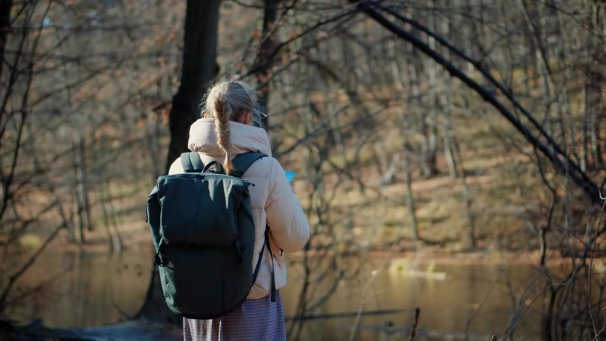 Traveling Trip Autumn Forest Walk And Looking Town Plan On Navigation Map For Journey. Woman Tourist Looking Paper Map And Exploring Park Route. Active Lifestyle On Vacation Travel Tourism Adventure