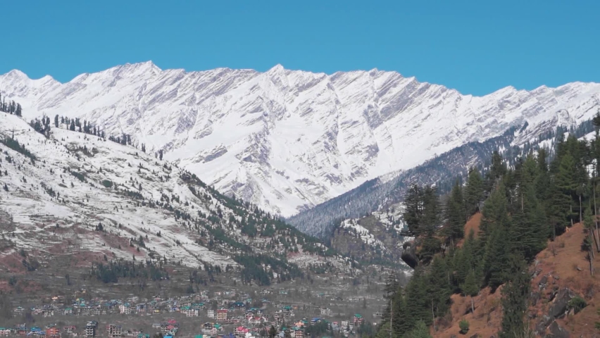 View of snow covered mountains after snowfall during the winter season at Manali in Himachal Pradesh, India. Himalayan Mountains covered by snow after snowfall. Nature background with copy space. | Shutterstock HD Video #1096997113