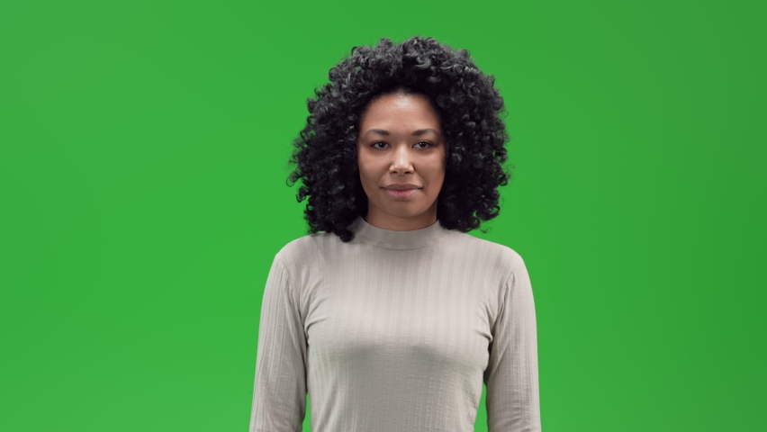 woman showing hand gesture boring conversation in studio green background