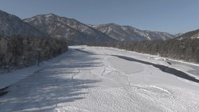 Beautiful landscape of a half-frozen lake and pine forest near mountains in winter. High quality 4k footage - Powered by Shutterstock - Get 15% off with code: PIKWIZARD15
