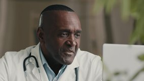 Doctor specialist african american man therapist practitioner male talk at computer web camera virtual medical consultation consulting patient online communicate in video chat give professional advice - Powered by Shutterstock - Get 15% off with code: PIKWIZARD15
