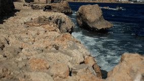 Waves and a motor boat at the edge of the Red Sea coast in Egypt. Slow motion video