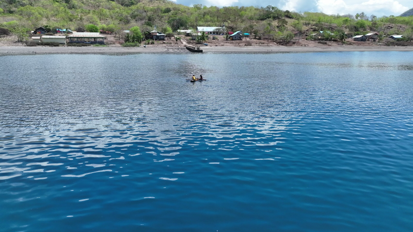 Children paddle their outrigger canoes in the quaint Beangabang Bay on the island of Pantar, near Alor, in Indonesia. This area is known for its incredibly high marine biodiversity.