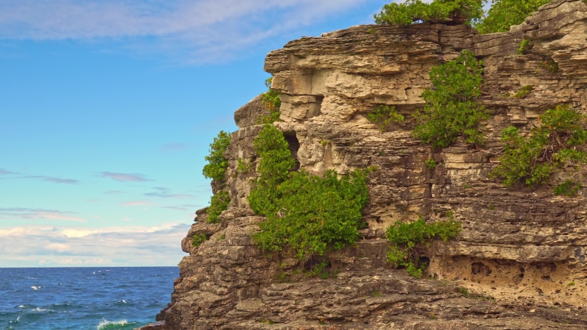Wide view of Indian Head Cove landscape near Grotto and Overhanging rock tourist attractions in Tobermory, Ontario, Canada. Caves of Bruce Peninsula National Park on lake Huron. Royalty-Free Stock Footage #1097011421