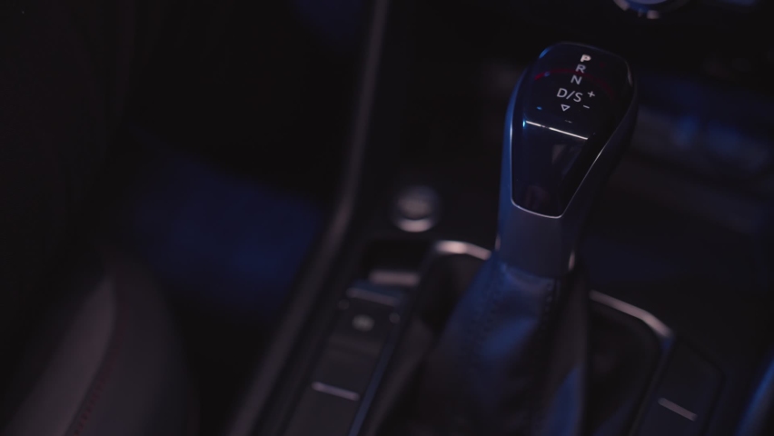 man switches automatic transmission in the car