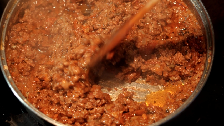 Cooking Bolognese Sauce For Pasta In Pan. Boiling Food On Pan. Delicious Italian Bolognese. Italian Lasagna Preparation. Making Bolognese Sauce For Lasagna. Italian Cuisine In Restaurant Make Pasta Royalty-Free Stock Footage #1097017403