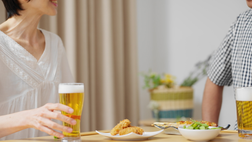 Image of a middle female and middle male couple dining together with beer in the evening. Royalty-Free Stock Footage #1097020197