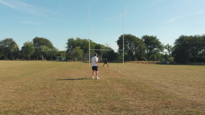 Friends playing a game of soccer in the park