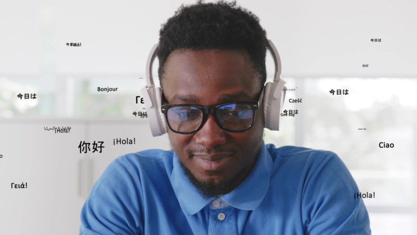 African-American man in headphones listen to music with different languages words hologram flying of headphones. Guy in earphones learn languages with holographic flying words.