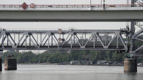 Side view of vertical-lift train bridge moving up above Don river in summer day. Real time video. Seelctive focus. Transportation theme.