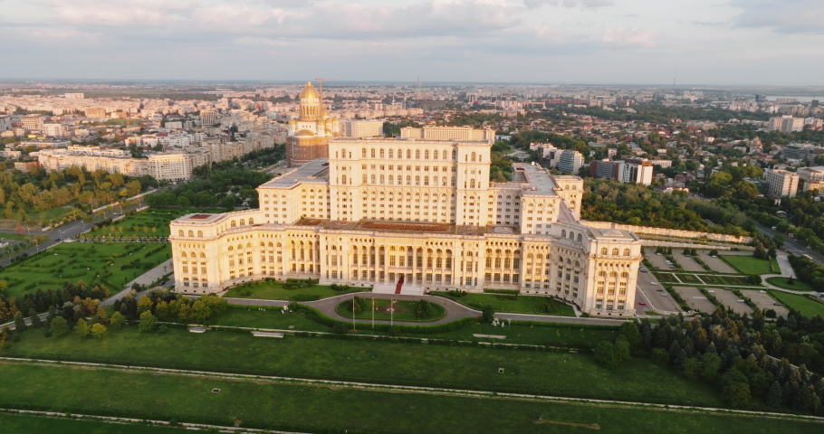 Palace of Parliament in Bucharest, Romania history Center aerial view drone turn at dawn in summer against blue sky. Architecture of last century. Go Everywhere. Travel
