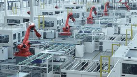 Time-lapse video of Automated Solar Panel Production Line with Orange Industrial Robot Arms. Looped video. Modern, Bright Manufacturing Facility.