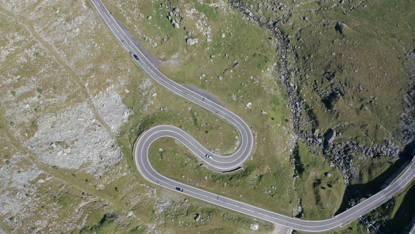 Amazing aerial video with the famous Transfagarasan mountain road between Transylvania and Muntenia with many vehicles slowly coming around the bends, Romania