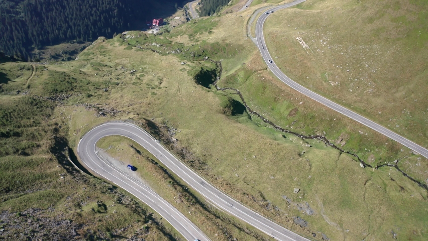 Amazing aerial video with the famous Transfagarasan mountain road between Transylvania and Muntenia with many vehicles slowly coming around the bends, Romania