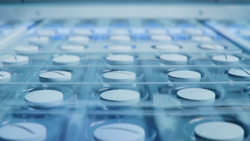 Close-up Shot of White Pills During Production and Packing Process on Modern Pharmaceutical Factory. Medical Drug Manufacturing. Royalty-Free Stock Footage #1097031355