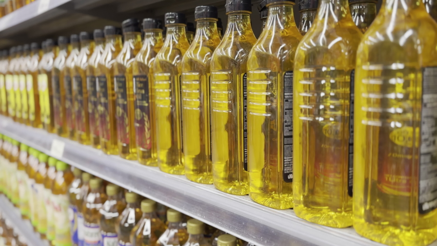 Rising prices cost of living global CPI index number surge up high in cooking extra virgin olive oil grocer market. Shelf in a row aisle showing food supply chain issues at retail store grocery mall. Royalty-Free Stock Footage #1097032737