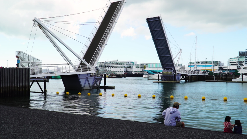 Wynyard Crossing (double bascule walking and cycling bridge) are lifting up to allow watercraft passage into the Viaduct Harbour area in Auckland, New Zealand