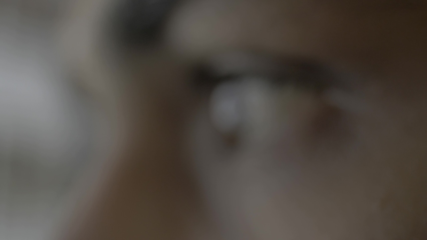 Super extreme close up of a female human eye reflecting a desktop screen while doom scrolling or doom surfing on the web putting unhealthy strain on the eyes Royalty-Free Stock Footage #1097034109