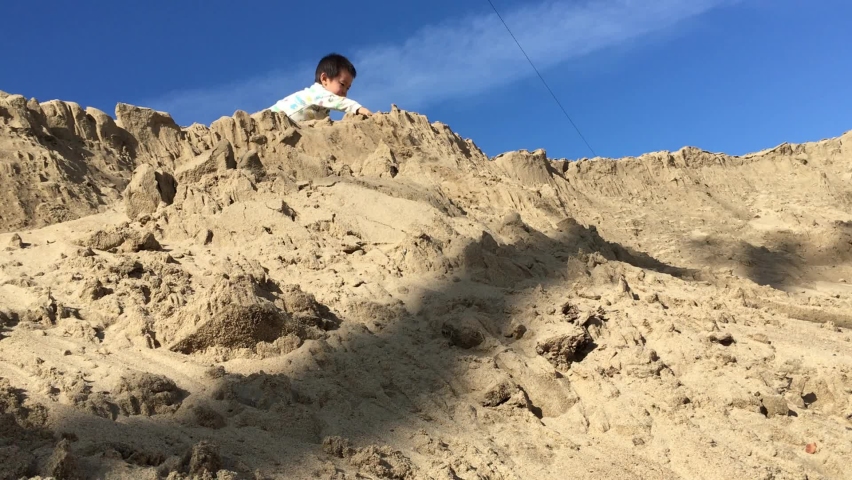Asian Boy playing on the sand hill. Full HD footage