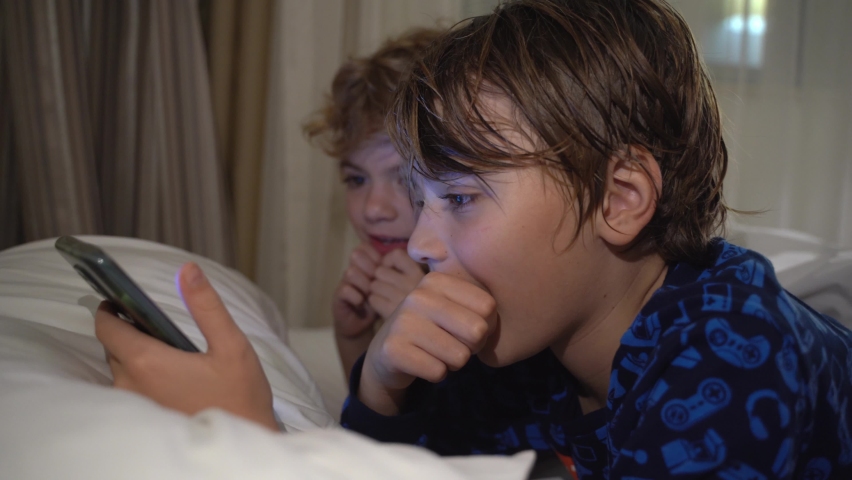 Children using digital tablet in the night watching Youtube. Child addiction to electronic devices. Spending free time. lifestyle activity.