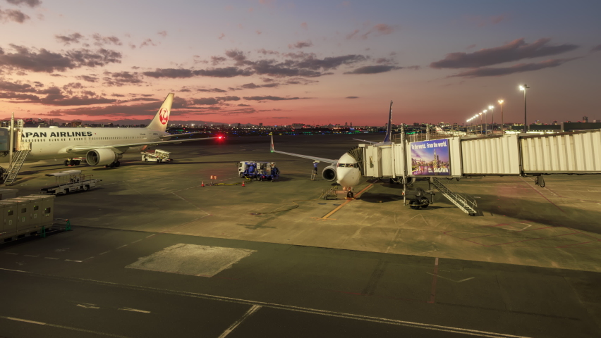 Tokyo, Japan - November 14, 2022: Plane arrives at gate as ground staff works on tarmac at Haneda Airport