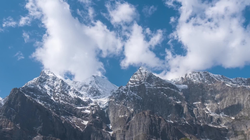 Zoom out Time lapse of clouds running on blue sky over mighty Himalaya mountains. Snow mountains at Lahaul Spiti District at Himachal Pradesh, India. Ken Burns effect. | Shutterstock HD Video #1097054579