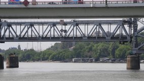 Side view of vertical-lift train bridge moving down above Don river in summer day. Real time video. Seelctive focus. Transportation theme.