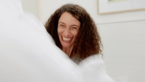 Couple, pillow fight and pov on the bed in the bedroom at their home being playful. Happy young woman, smile and energy, laugh or playing while have friendly game in their house in morning together - Powered by Shutterstock - Get 15% off with code: PIKWIZARD15