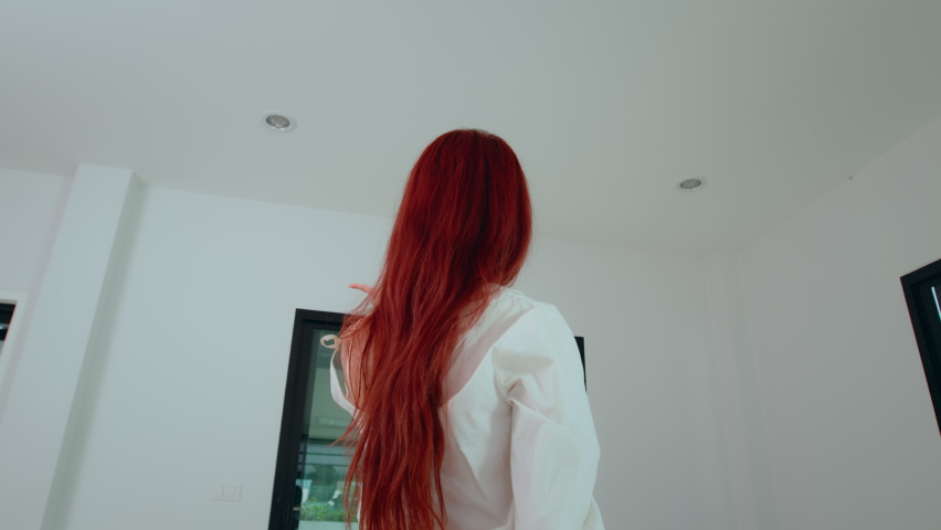 Asian woman homeowner checking detail before moving to her new house. Home relocation. Family housing and Real estate rental service concept.