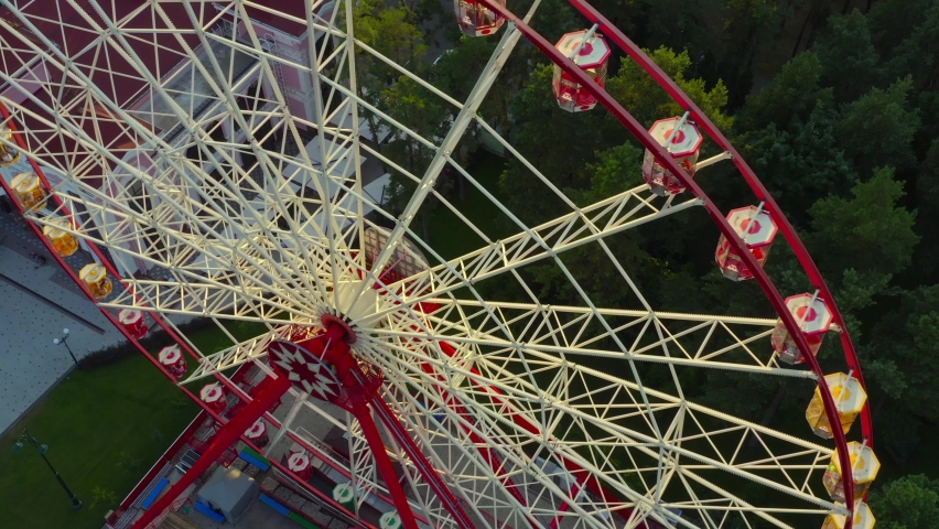 Ferris wheel against the backdrop of the cityscape - Drone shot. Attraction big ferris wheel in Kharkiv. Gorky Park, Kharkiv Ukraine. Royalty-Free Stock Footage #1097064649