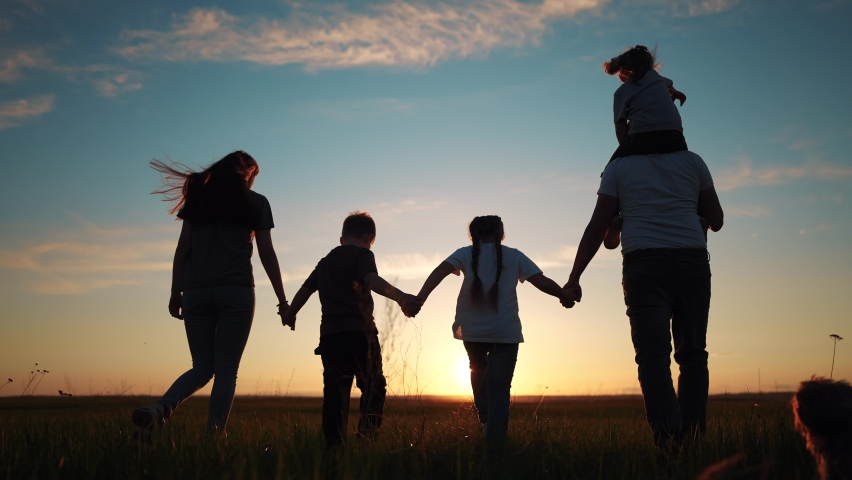 people in the park silhouette. happy family kid dream holiday concept. friendly family holding hands walking dog at sunset in the park silhouette. big family silhouette walk in lifestyle the park Royalty-Free Stock Footage #1097066795