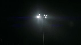 HANDHELD View of stadium flood lights are turning on, heavy rain, bad weather - Powered by Shutterstock - Get 15% off with code: PIKWIZARD15