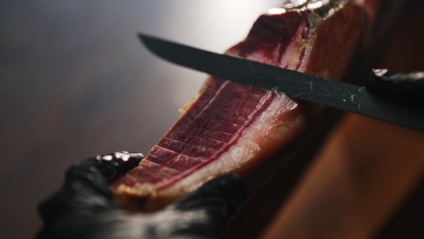 Chef cutting dry-cured spanish ham Jamon. Royalty-Free Stock Footage #1097070993