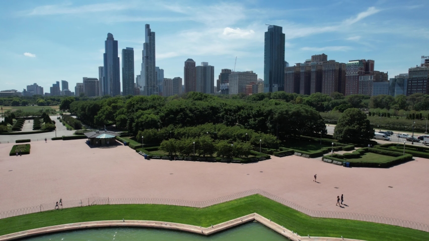 Reverse aerial over landmark of Chicago, Buckingham Fountain in center of Grant Park. United States.
