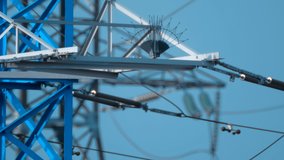 In the field, high-voltage power line masts in large numbers against the blue sky, which deliver expensive, by today's times, electricity to cities, villages, factories, plants and other industrial  - Powered by Shutterstock - Get 15% off with code: PIKWIZARD15