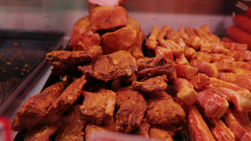 Wide range of smoked beef and lamb along with different types of salami in show window. Shop layout done in meat department. | Shutterstock HD Video #1097088687
