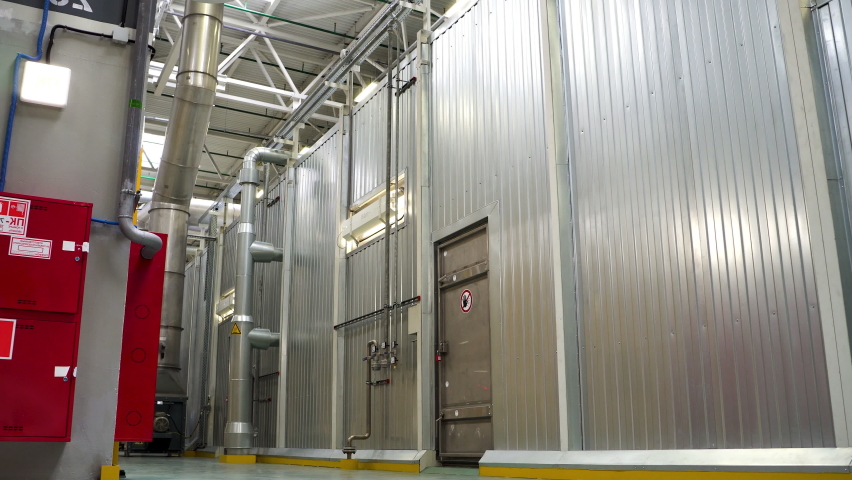 Large isolated room. Scene. A huge empty garage with gray walls.