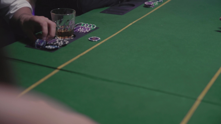 Men gambling at the poker table. Woman hands out cards to players throwing them on the table to each player