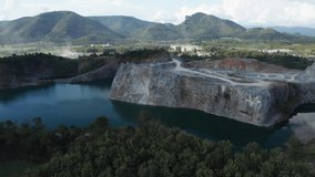 Aerial view drone fly over machine excavator trucks dig coal mining. Environmental issue and pollutions. Factory mining industry. Grunge stone in quarry with mountain hills. Footage b roll.