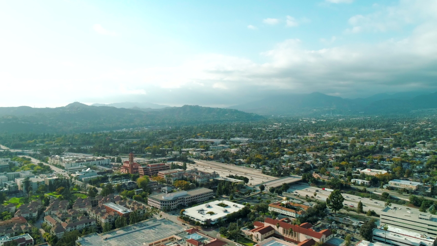 Scenic drone aerial shot of Los Angeles rolling hills of Southern California surrounded by homes and mountains. Daylight, summer. USA. High quality 4k footage