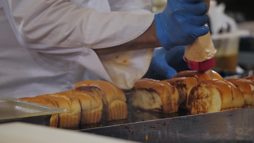 Grill Brioche Sandwich with salmon red fish on Food Festival, toast in the market put up for sale.