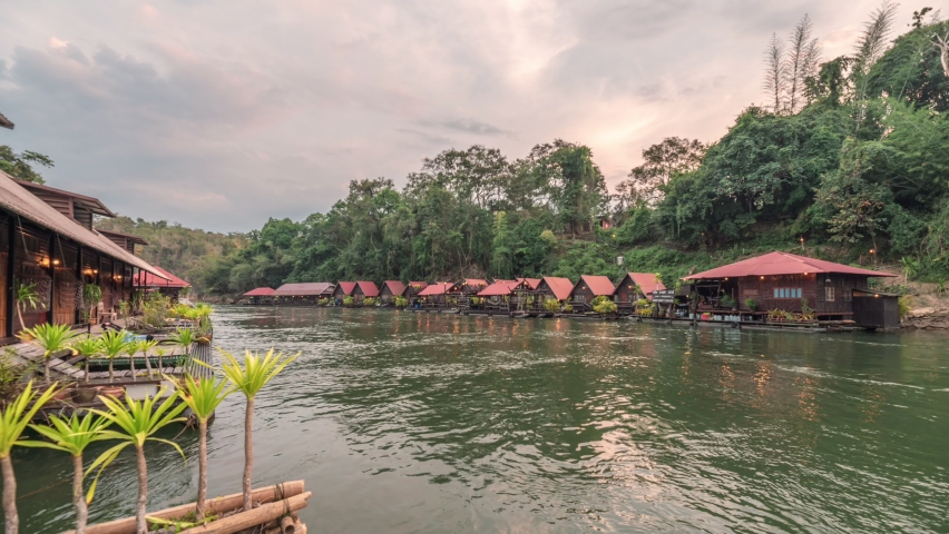 Time lapse of Wooden raft resort with lighting floating on the River Kwai in tropical rainforest at Kanchanaburi, Thailand