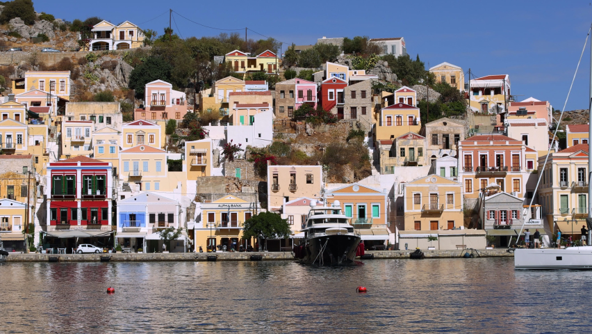 Symi island harbour port. Yacht passing through 