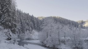 Beautiful motion panning footage of amazing and scenic landscape view of winter in Romanian village during snow